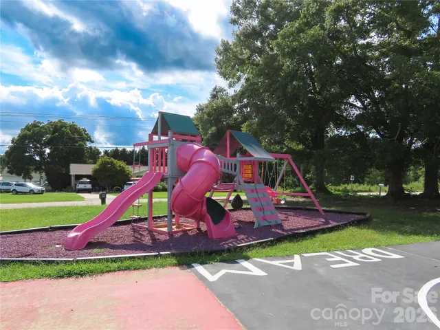 a swimming pool with big trees