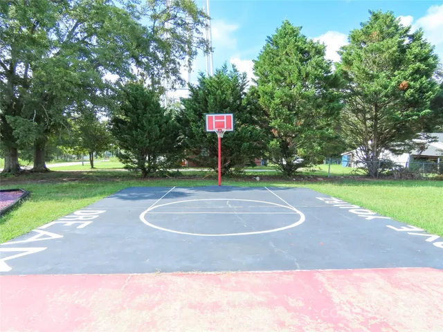 a swimming pool with big trees