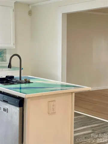 a kitchen with granite countertop a sink and cabinets