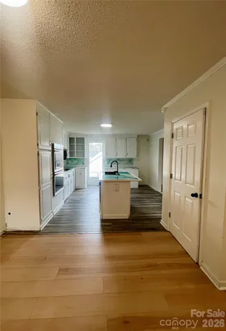 an empty room with windows and cabinet