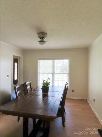 a view of a dining room with a table and chairs
