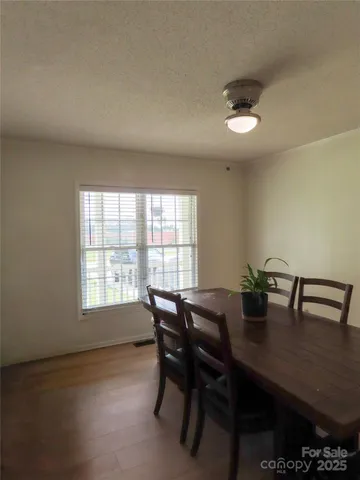 a view of a dining room with furniture and window