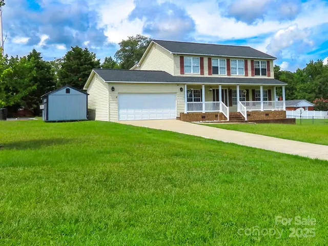 a front view of a house with a yard table and chairs