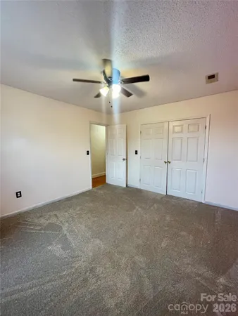 a view of room with wooden floor and ceiling fan