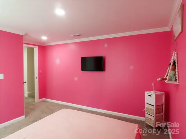 a bedroom with pink walls and pink walls