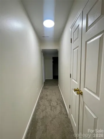 an empty room with closet and windows