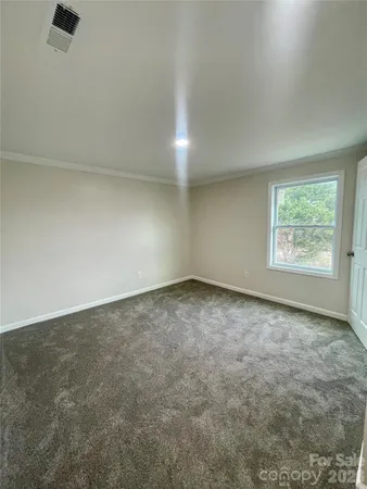a hallway with a couch and dresser