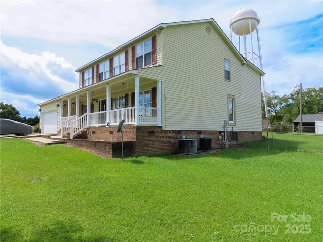 a front view of a house with a garden and deck