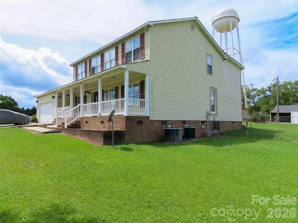 a front view of a house with a garden and deck