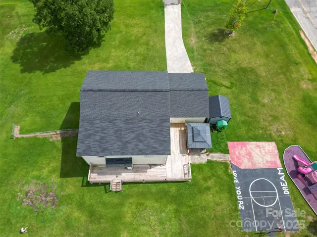 an aerial view of a house with pool table and chairs