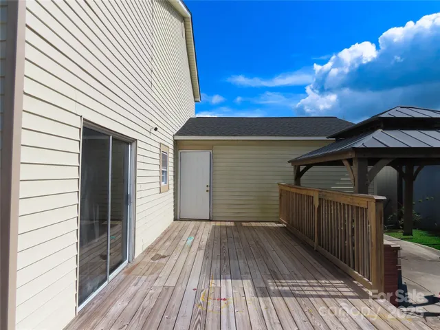 a view of a wooden deck besides a house