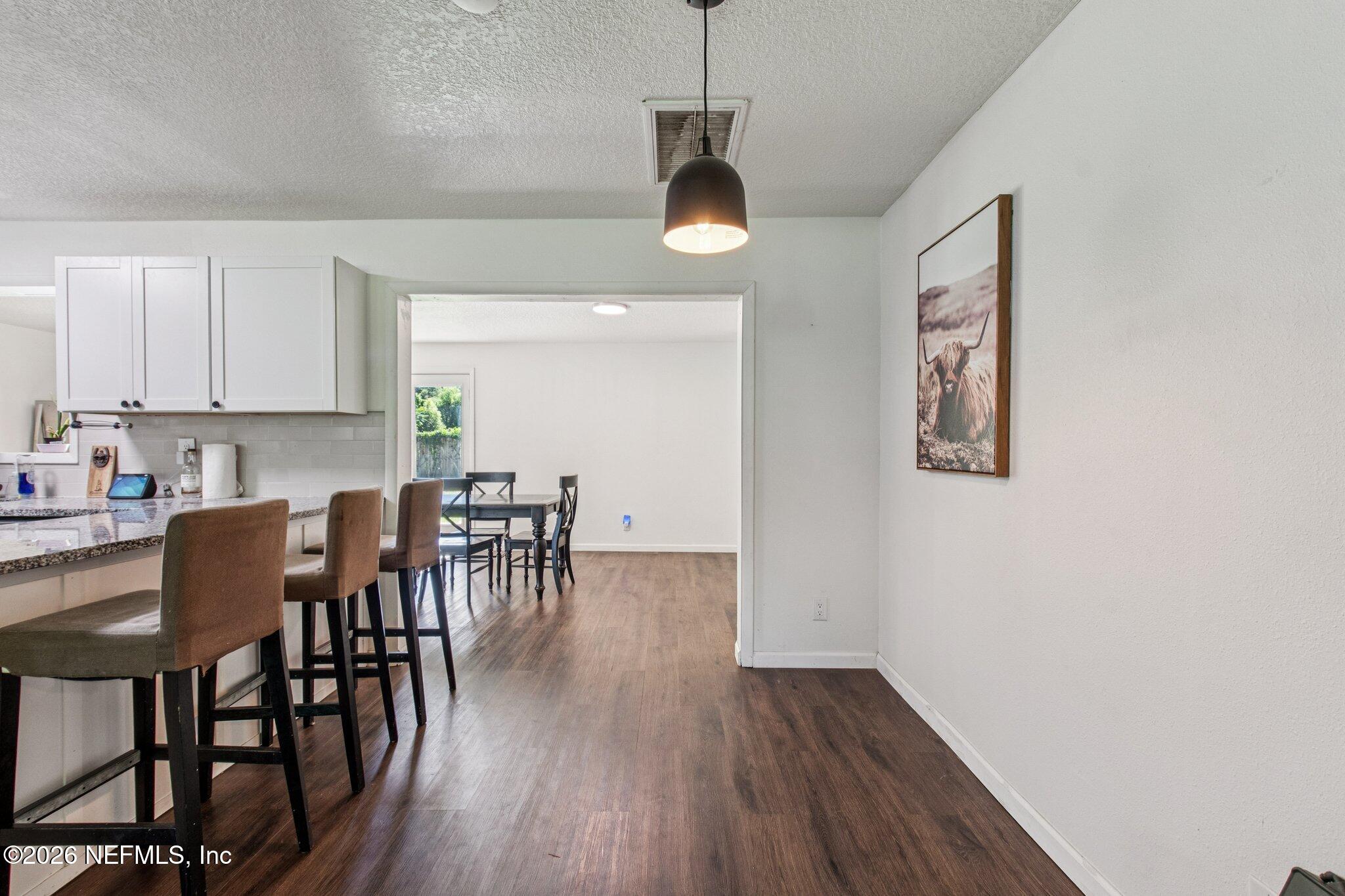 1417 Clock Street Jacksonville, FL 32211 - Photo 13 of 39 a view of a dining room with furniture and wooden floor