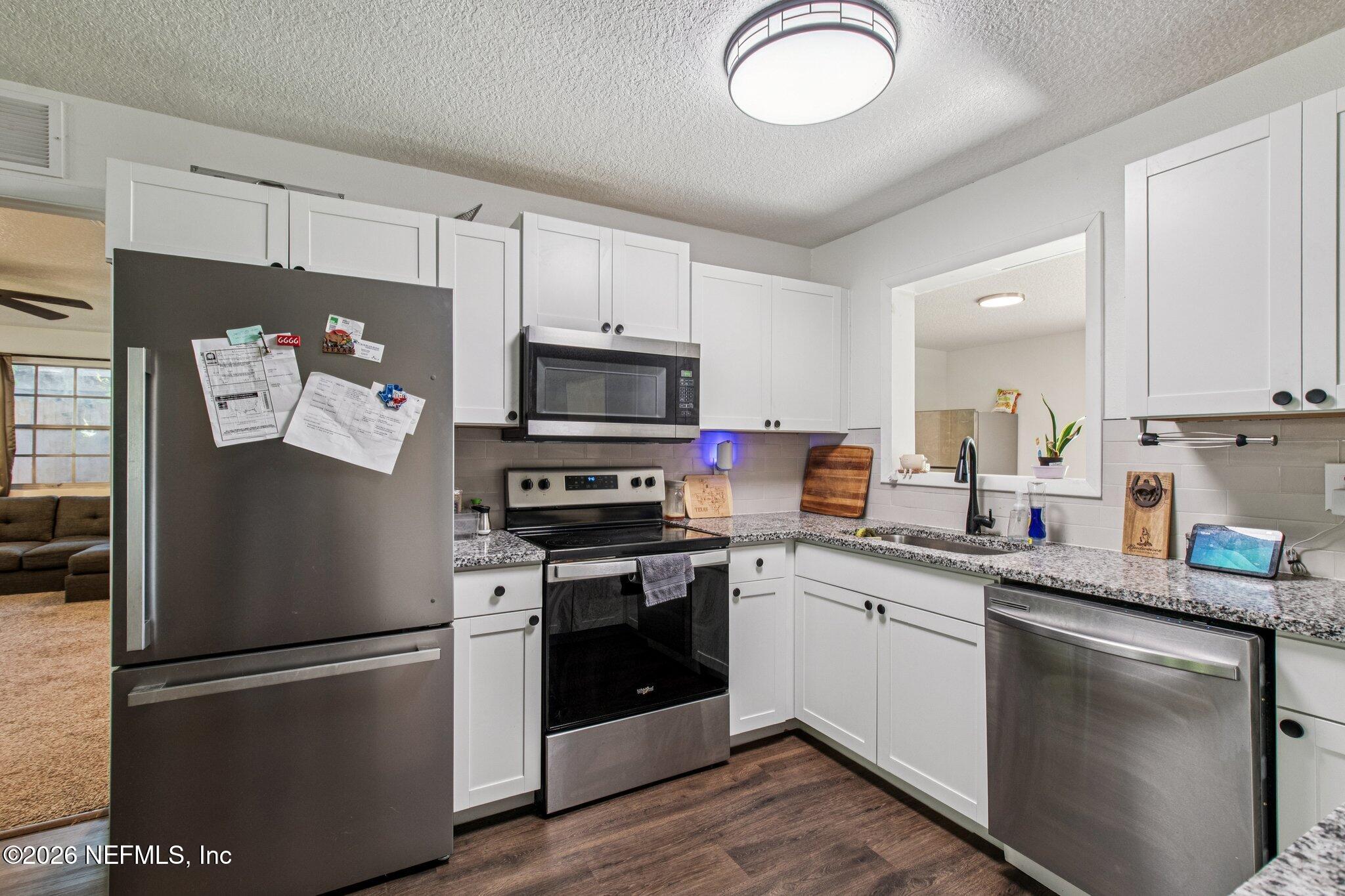 1417 Clock Street Jacksonville, FL 32211 - Photo 17 of 39 a kitchen with stainless steel appliances granite countertop a refrigerator sink and stove