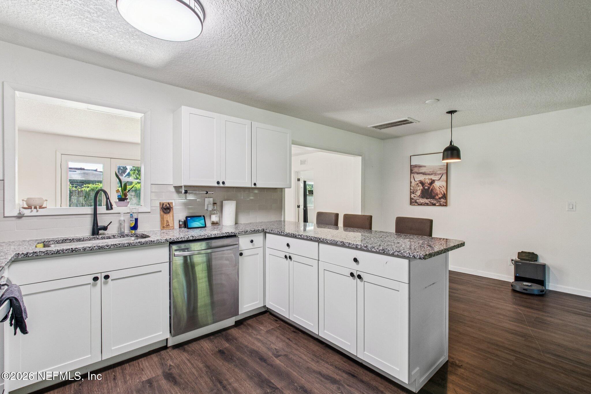 1417 Clock Street Jacksonville, FL 32211 - Photo 18 of 39 a kitchen with a sink cabinets and wooden floor