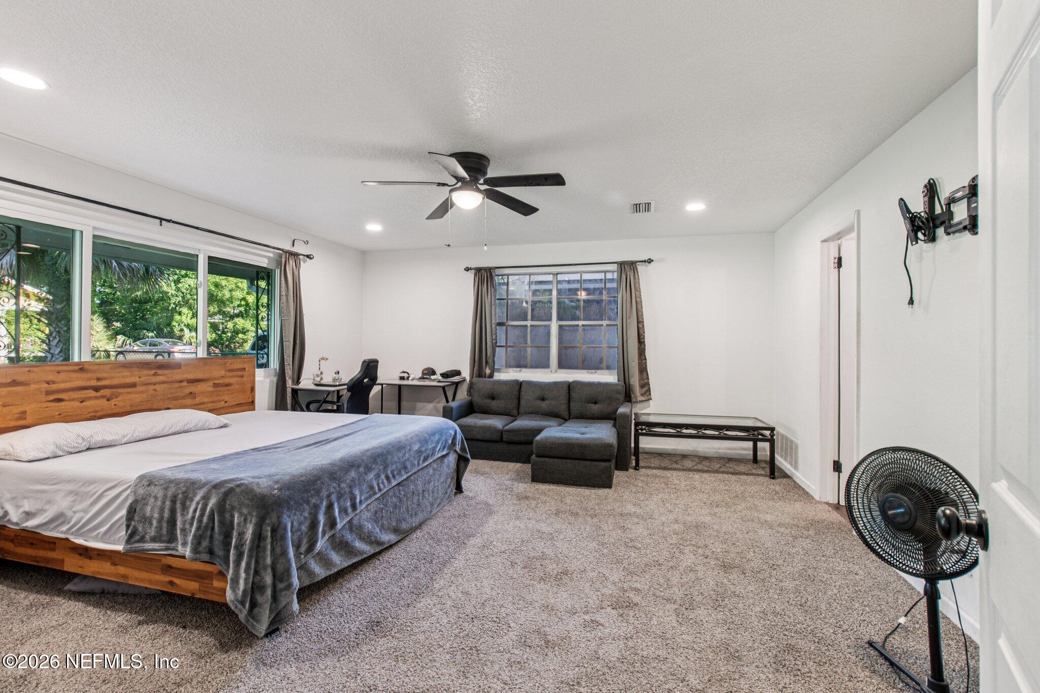 1417 Clock Street Jacksonville, FL 32211 - Photo 20 of 39 a bedroom with a bed a chandelier and a window