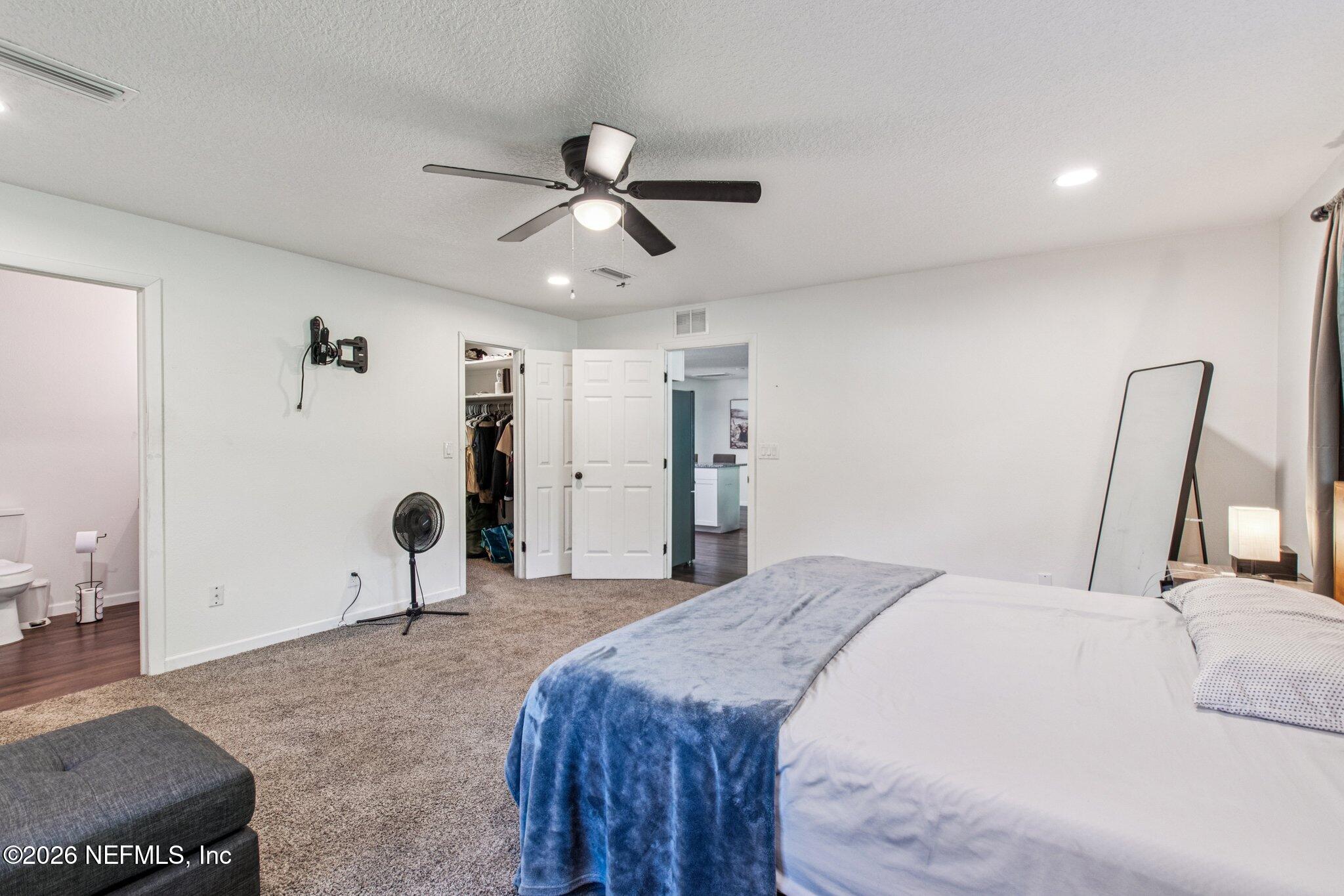 1417 Clock Street Jacksonville, FL 32211 - Photo 21 of 39 a bedroom with a bed and a mirror