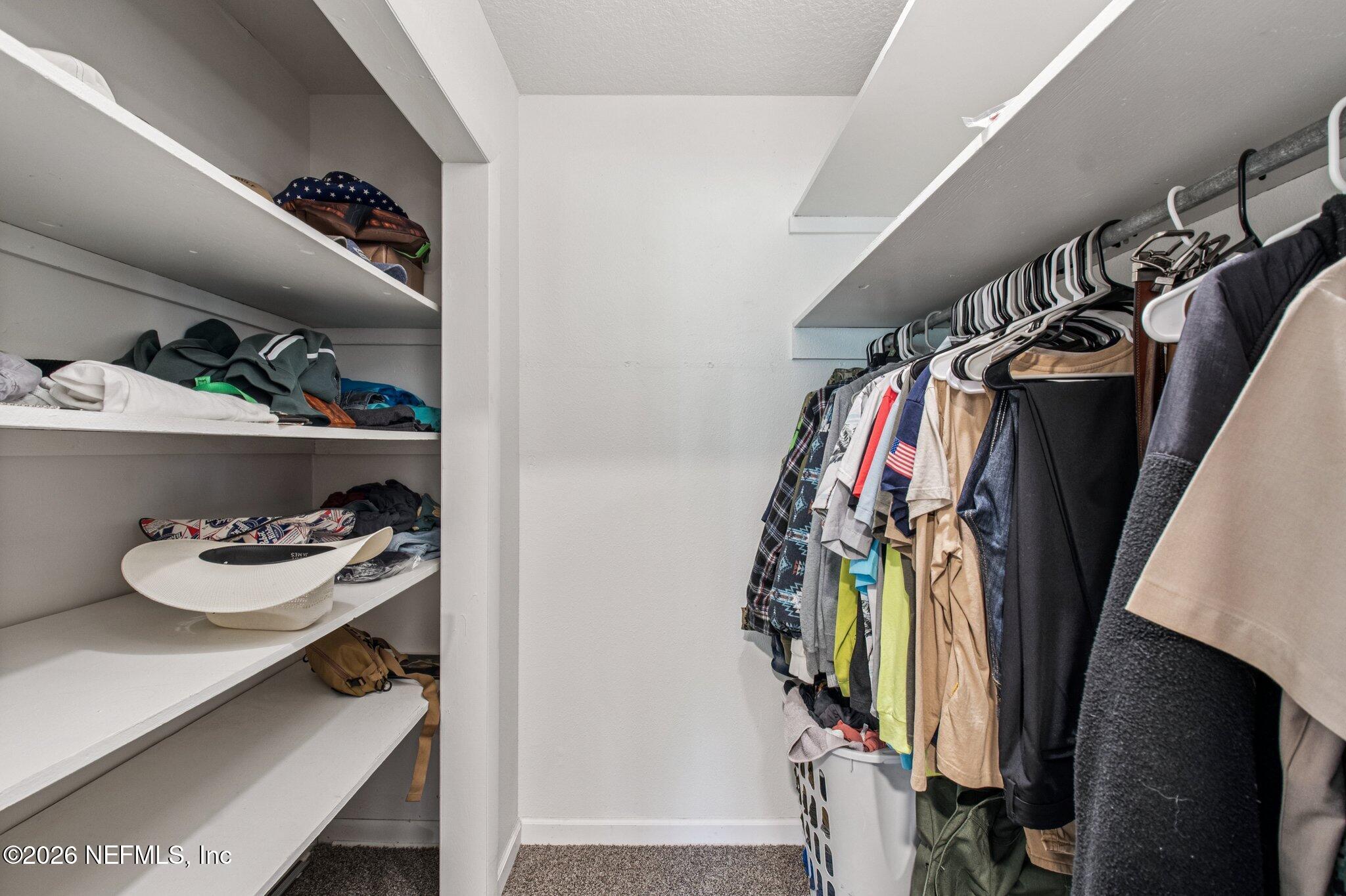 1417 Clock Street Jacksonville, FL 32211 - Photo 23 of 39 a view of walk in closet with clothes and shoes