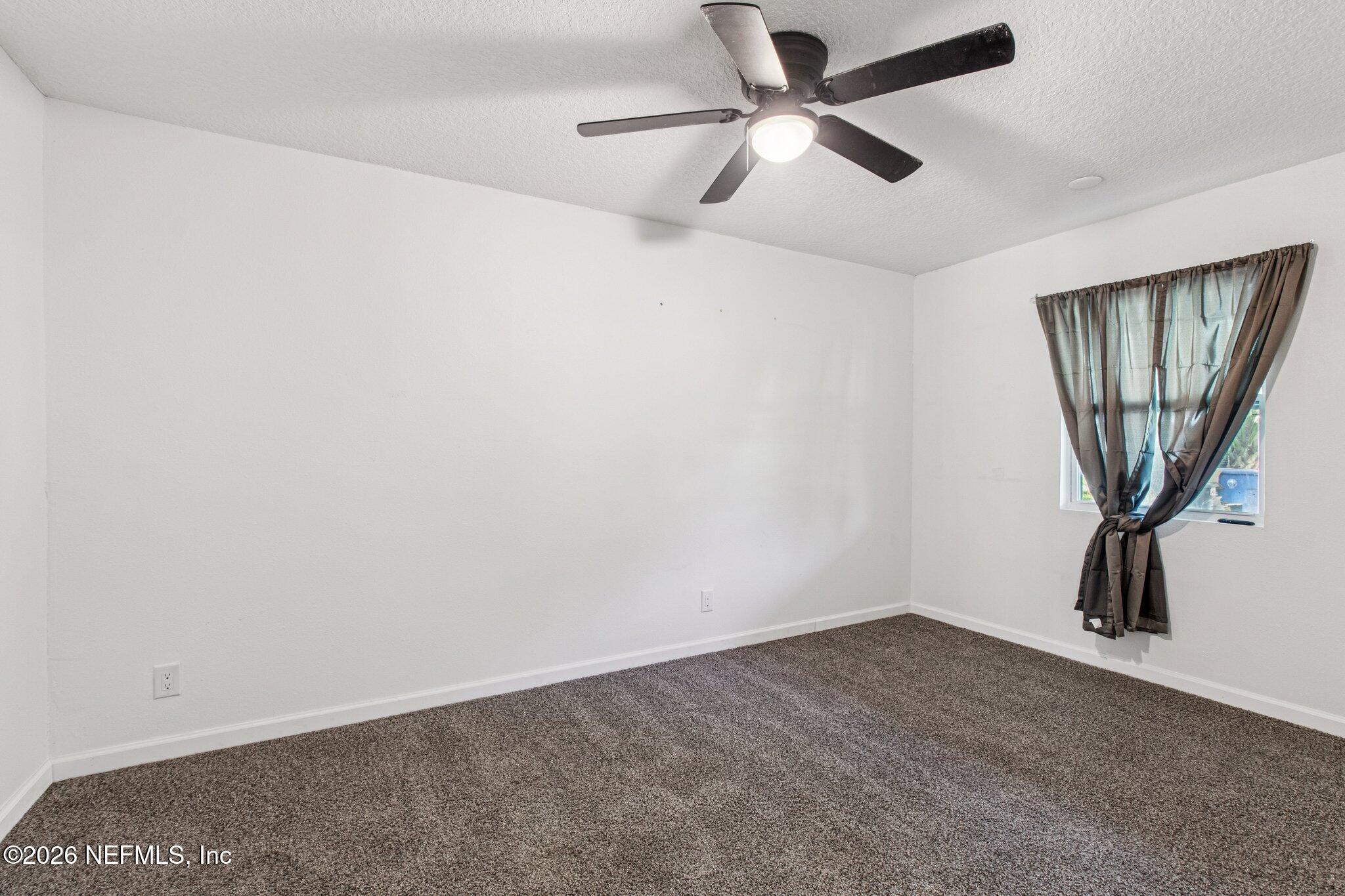 1417 Clock Street Jacksonville, FL 32211 - Photo 28 of 39 an empty room with a window and a fan