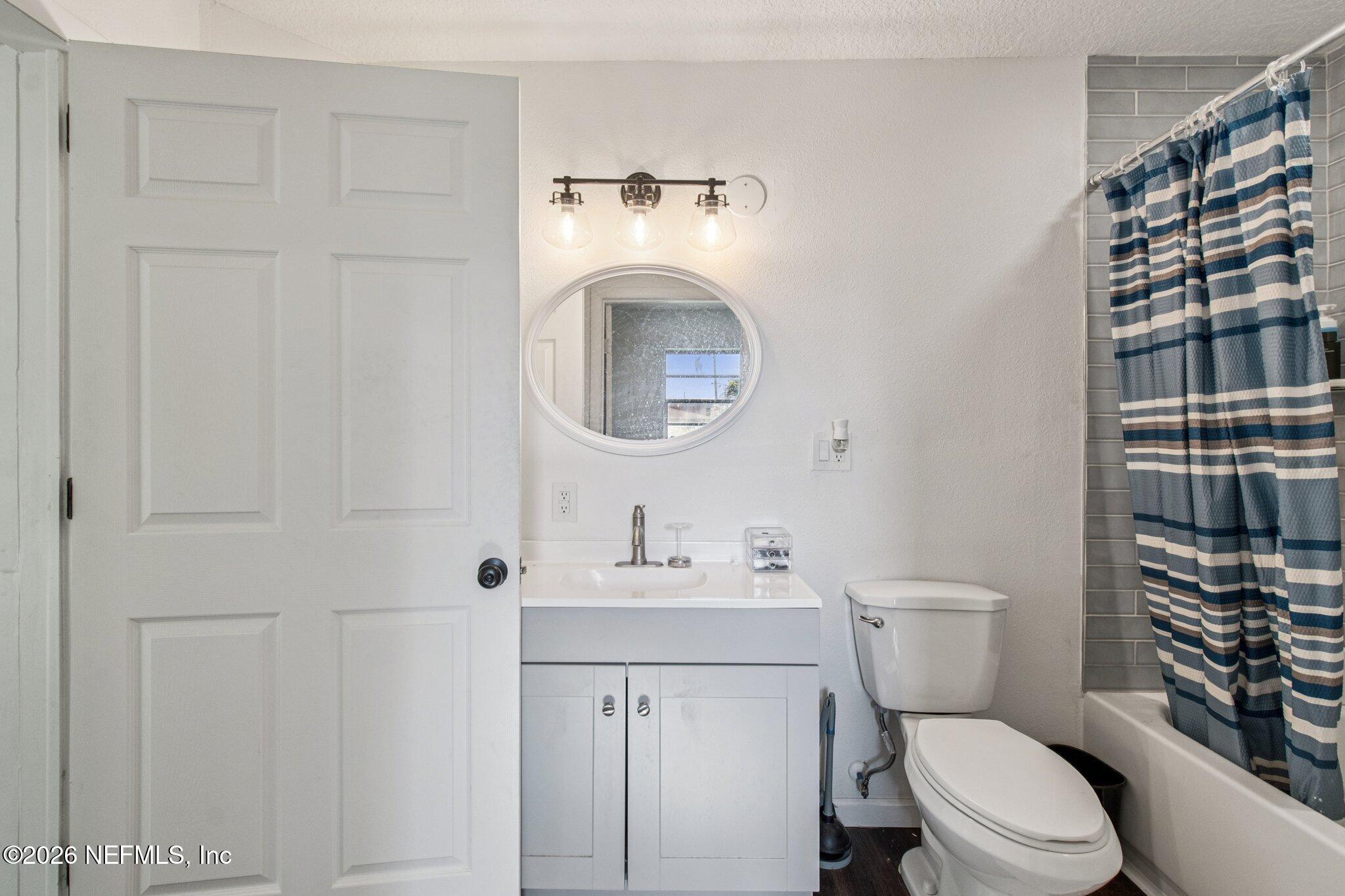 1417 Clock Street Jacksonville, FL 32211 - Photo 34 of 39 a white toilet sitting next to a bathroom sink