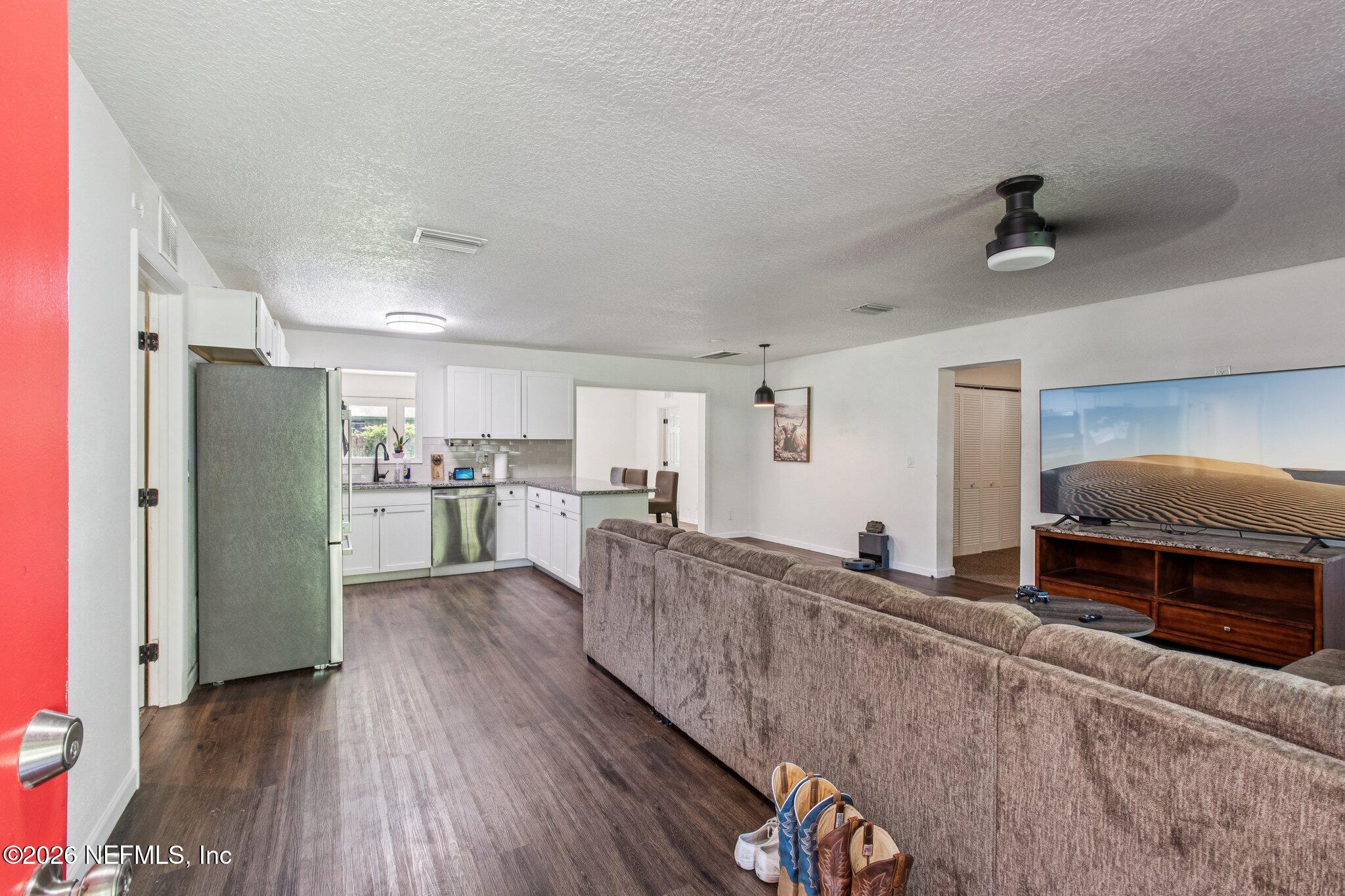 1417 Clock Street Jacksonville, FL 32211 - Photo 6 of 39 a living room with stainless steel appliances kitchen island granite countertop furniture and a kitchen view