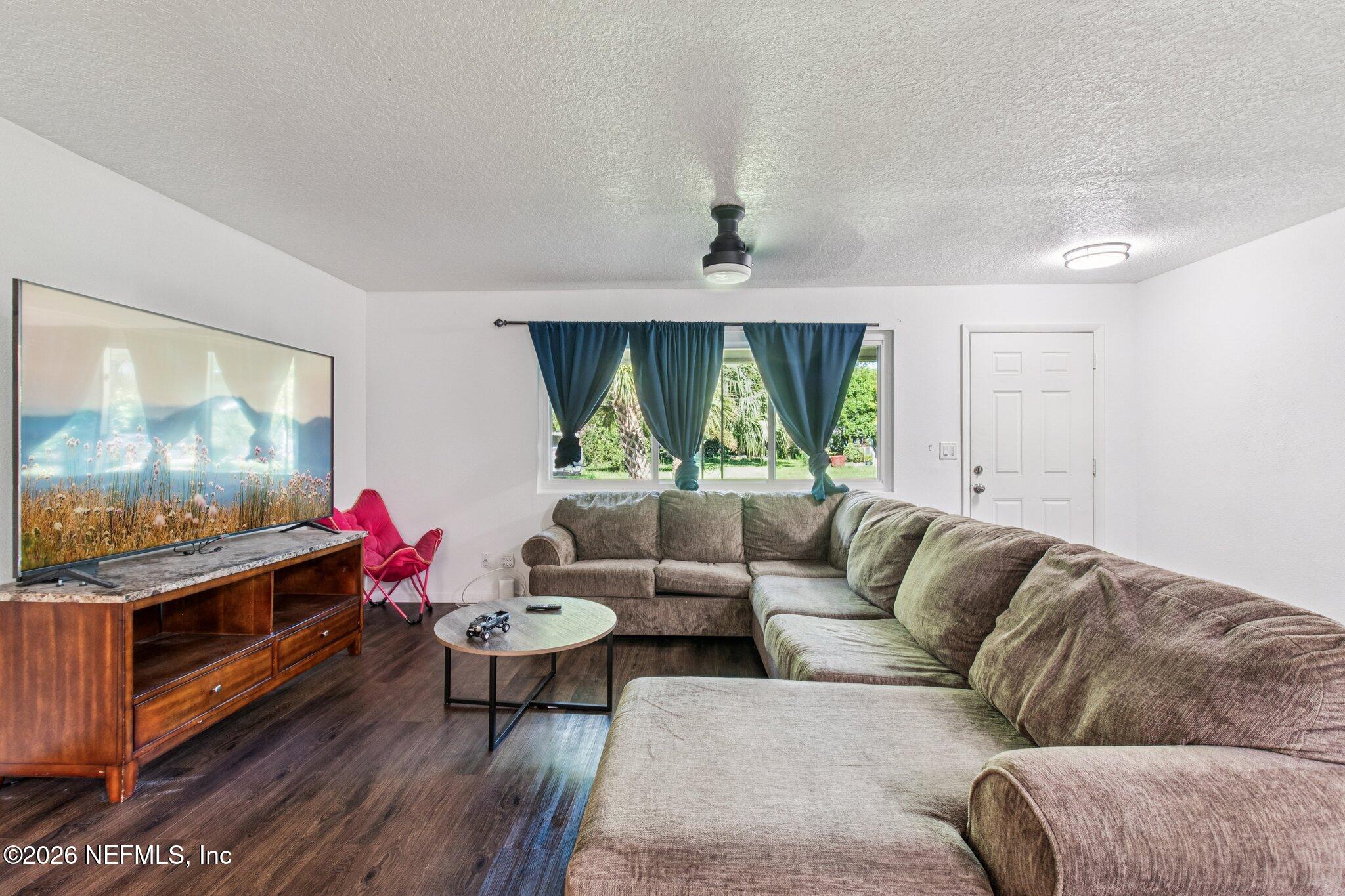 1417 Clock Street Jacksonville, FL 32211 - Photo 7 of 39 a living room with furniture and a flat screen tv