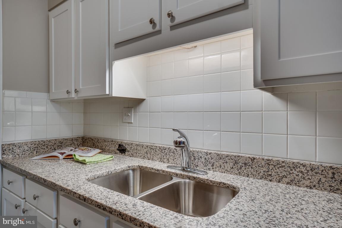 5811 Cambridge Drive, Unit 674 Springfield, VA 22152 - Photo 9 of 37 a kitchen with a sink and cabinets