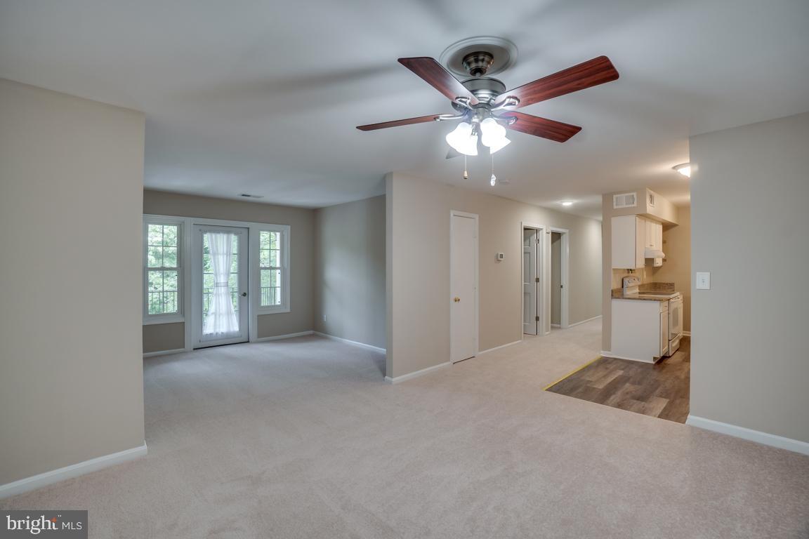5811 Cambridge Drive, Unit 674 Springfield, VA 22152 - Photo 10 of 37 a view of a big room with a chandelier fan and windows