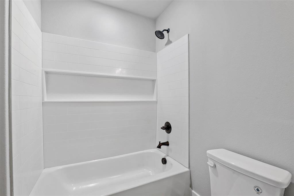 468 Peace Lily Way Tolar, TX 76476 - Photo 22 of 36 a bathroom with a bathtub and a toilet