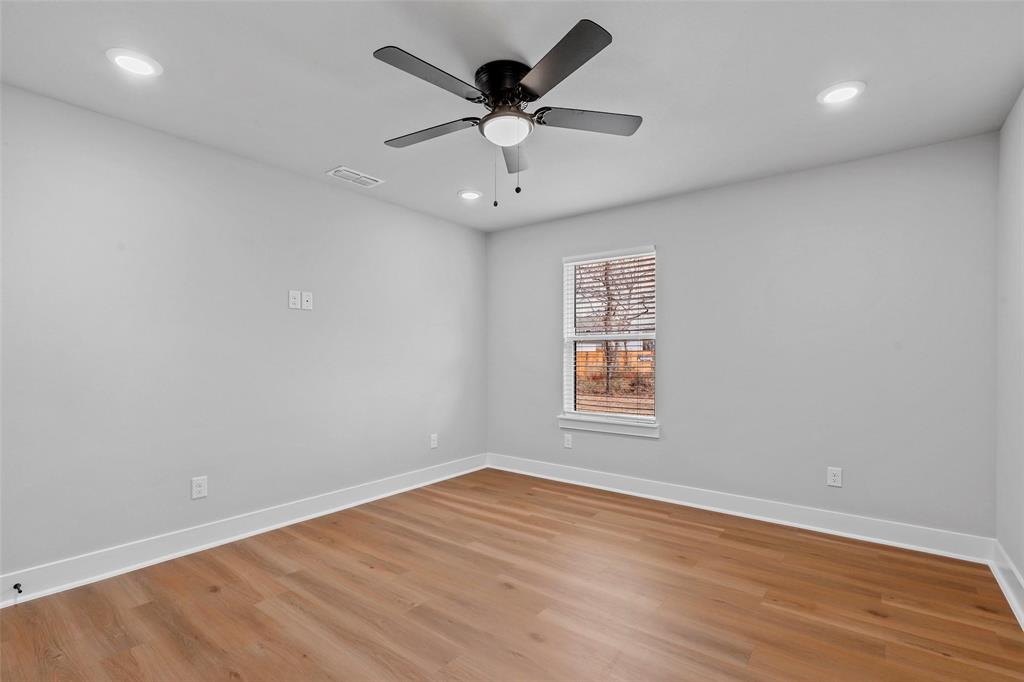 468 Peace Lily Way Tolar, TX 76476 - Photo 32 of 36 an empty room with wooden floor and ceiling fan