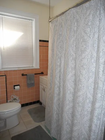 a bathroom with a toilet and a shower