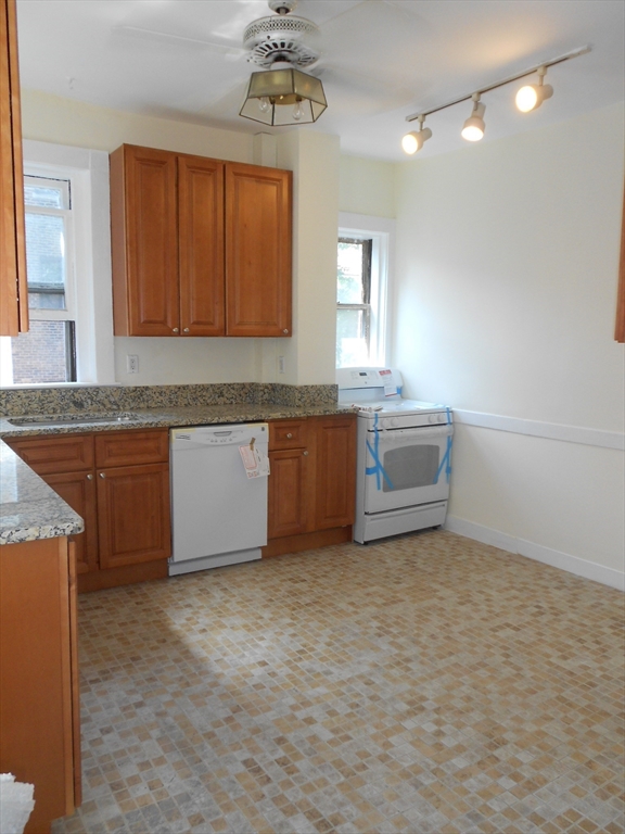 6 Beals Street, Unit 2 Brookline, MA 02446 - Photo 9 of 9 a view of a kitchen with microwave and cabinets