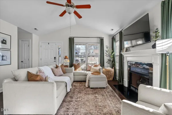 a living room with furniture and a fireplace