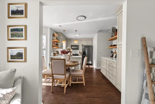 a dining room with furniture and wooden floor