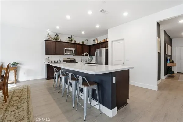 a large kitchen with a table and chairs