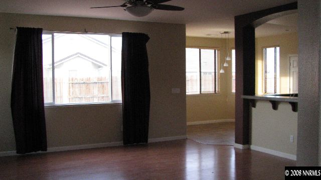1751 Trek Trail Reno, NV 89521 - Photo 2 of 7 a view of an empty room with wooden floor and a window