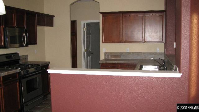 1751 Trek Trail Reno, NV 89521 - Photo 4 of 7 a kitchen with a stove and a refrigerator