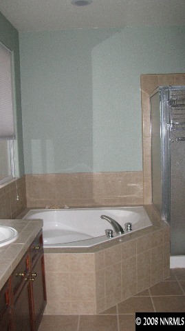 1751 Trek Trail Reno, NV 89521 - Photo 5 of 7 a bathroom with a granite countertop sink and a mirror