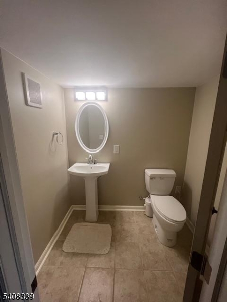 533 Edgeworth Street Middlesex, NJ 08846 - Photo 11 of 11 a bathroom with a toilet and a mirror
