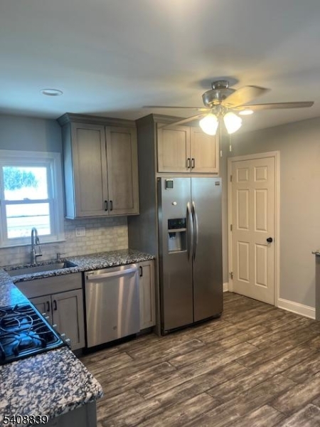 533 Edgeworth Street Middlesex, NJ 08846 - Photo 3 of 11 a kitchen with stainless steel appliances granite countertop a refrigerator a sink dishwasher a stove with wooden cabinets and floor