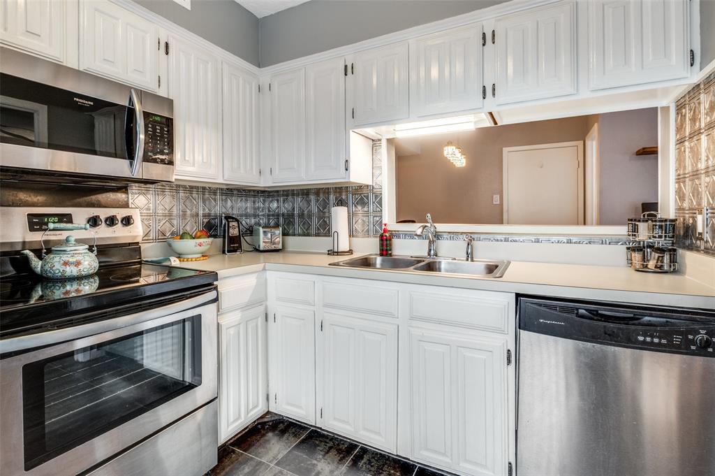 5626 Preston Oaks Road, Unit 31B Dallas, TX 75254 - Photo 6 of 17 a kitchen with stainless steel appliances granite countertop a sink and a stove