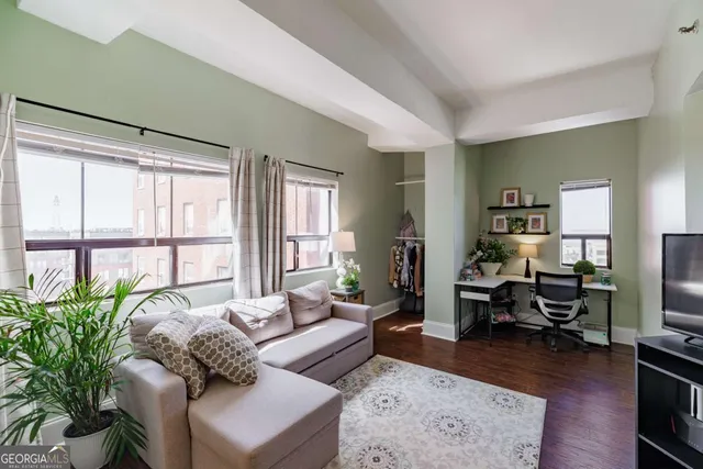 a living room with furniture large window and a table