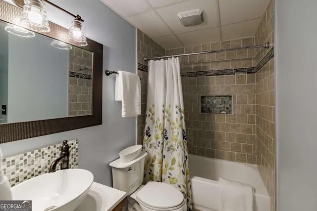 a bathroom with a toilet and shower
