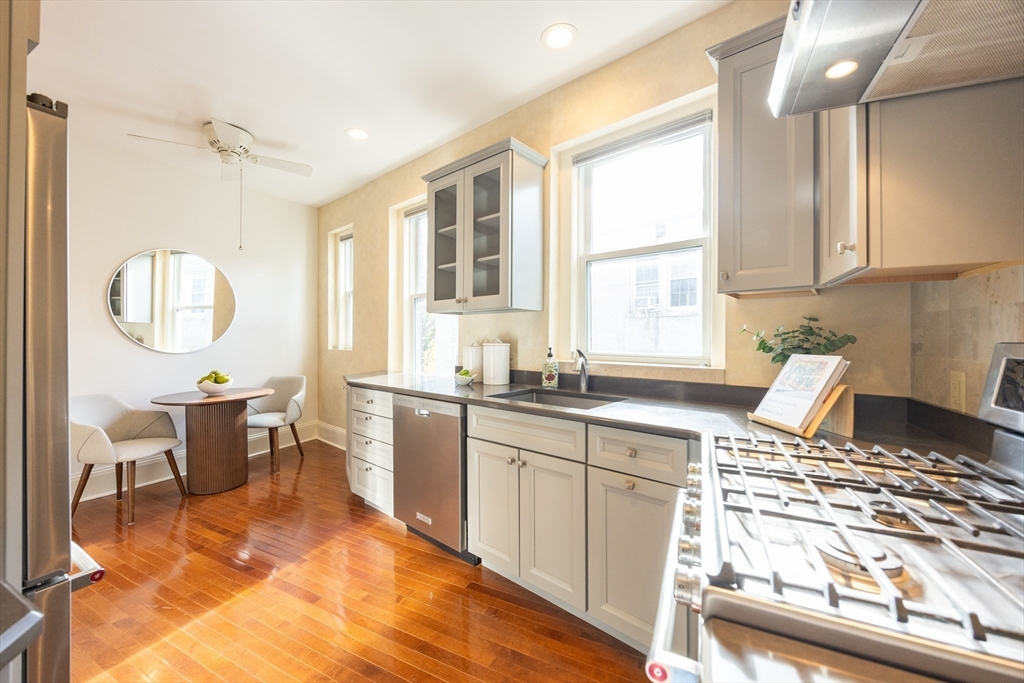 58 Dwight Street, Unit 6 Brookline, MA 02446 - Photo 11 of 21 a kitchen with a sink stove and cabinets