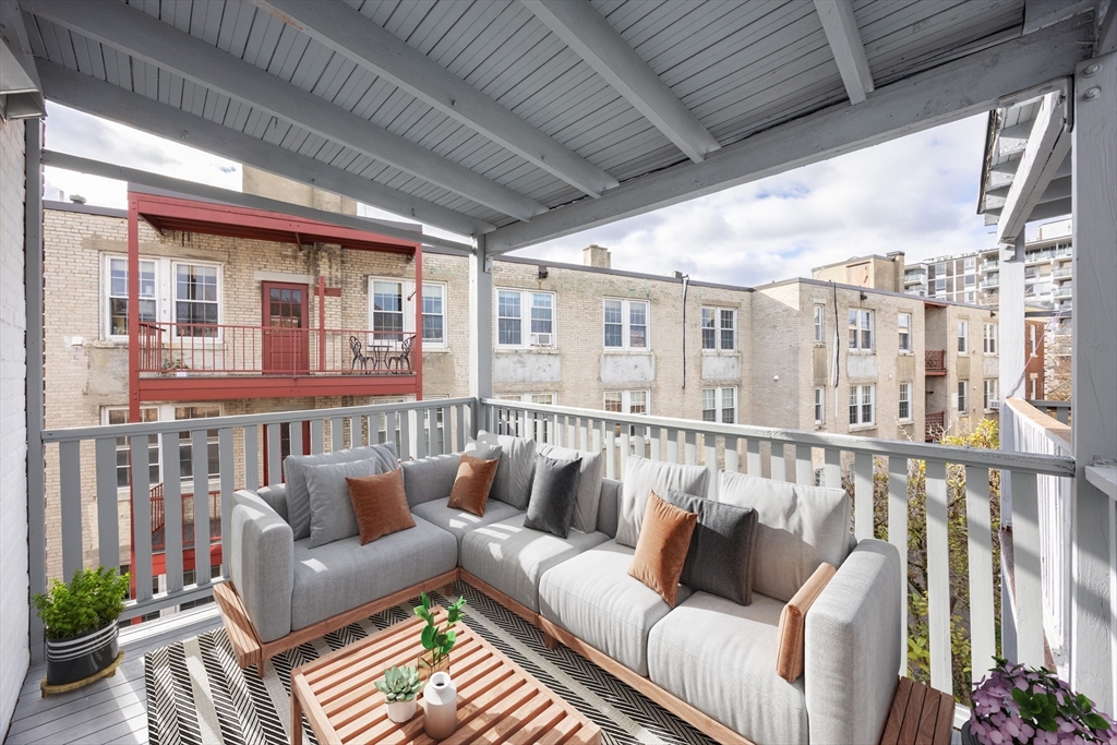 58 Dwight Street, Unit 6 Brookline, MA 02446 - Photo 19 of 21 a balcony with furniture and wooden floor