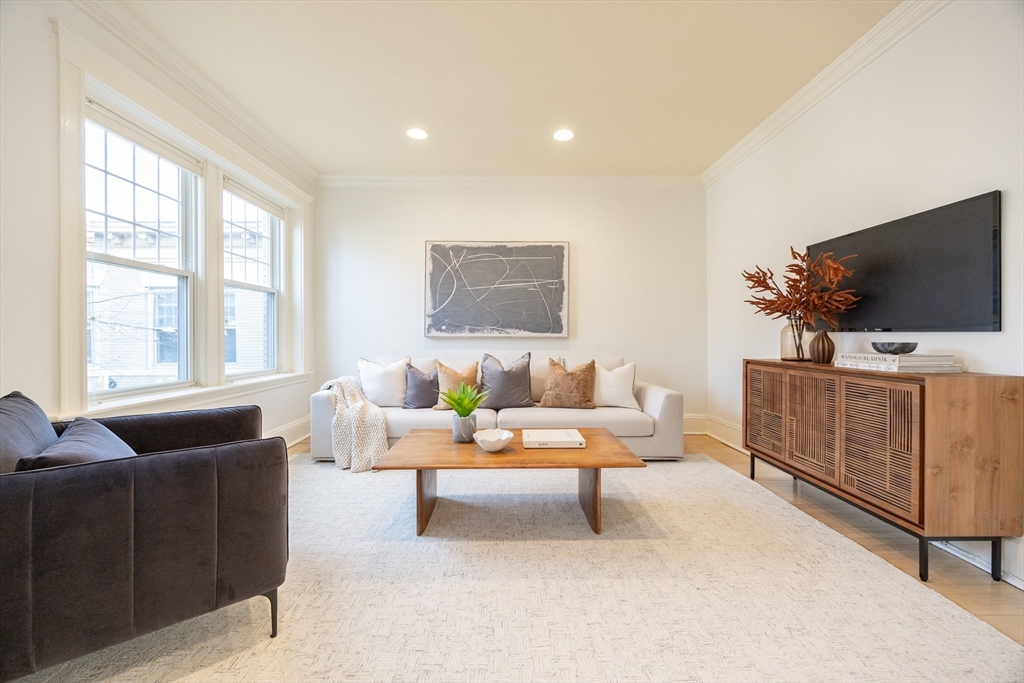 58 Dwight Street, Unit 6 Brookline, MA 02446 - Photo 6 of 21 a living room with furniture and flat screen tv