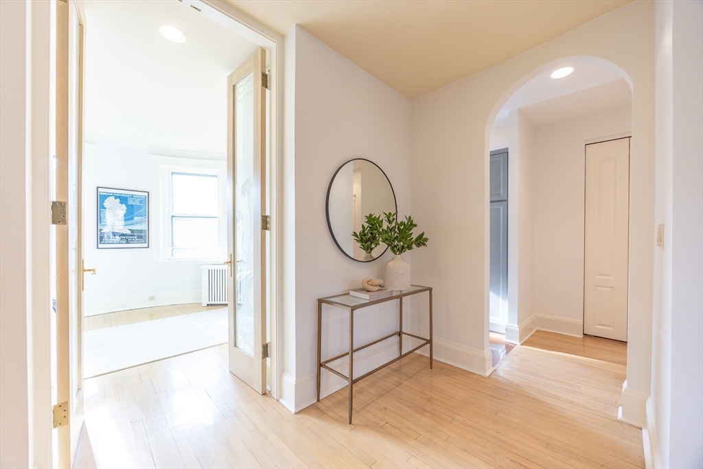 58 Dwight Street, Unit 6 Brookline, MA 02446 - Photo 8 of 21 a view of a hallway with entryway wooden floor and front door
