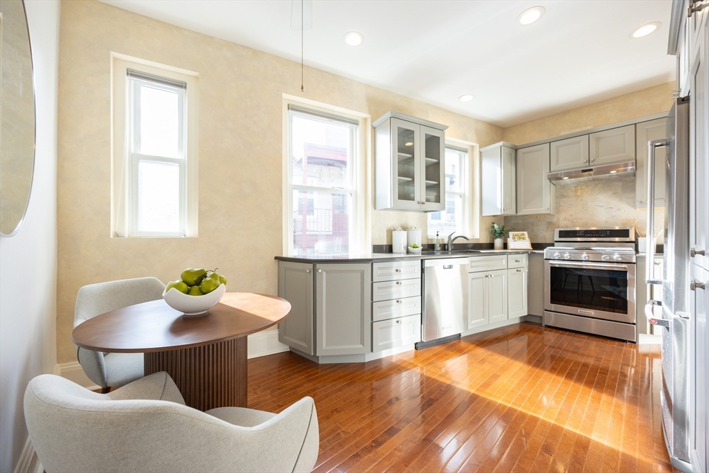 58 Dwight Street, Unit 6 Brookline, MA 02446 - Photo 10 of 21 a kitchen with a sink cabinets and window
