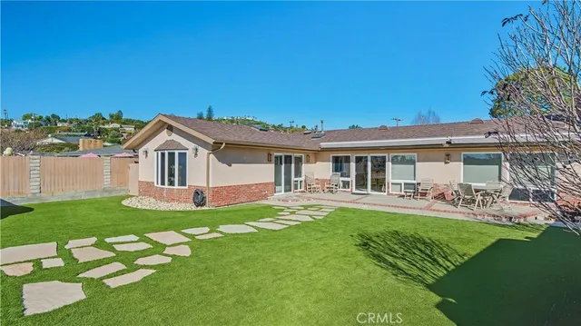 a front view of a house with swimming pool garden and patio