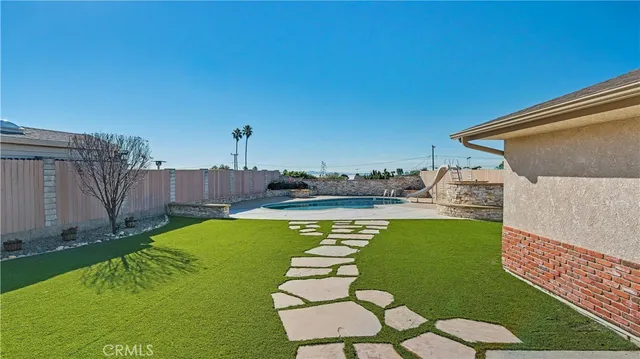 a swimming pool with outdoor seating and yard