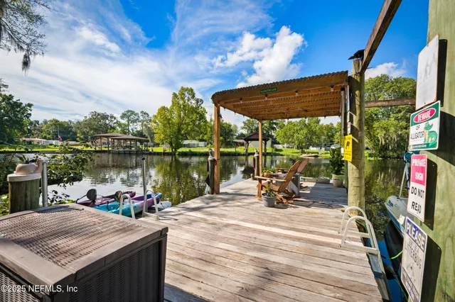 a view of a lake with a table chairs and a table